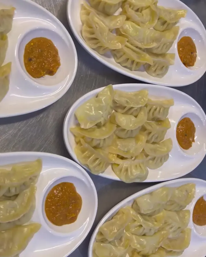 Plates of momo dumplings with dipping sauce, made at Blessings Fresh Sushi