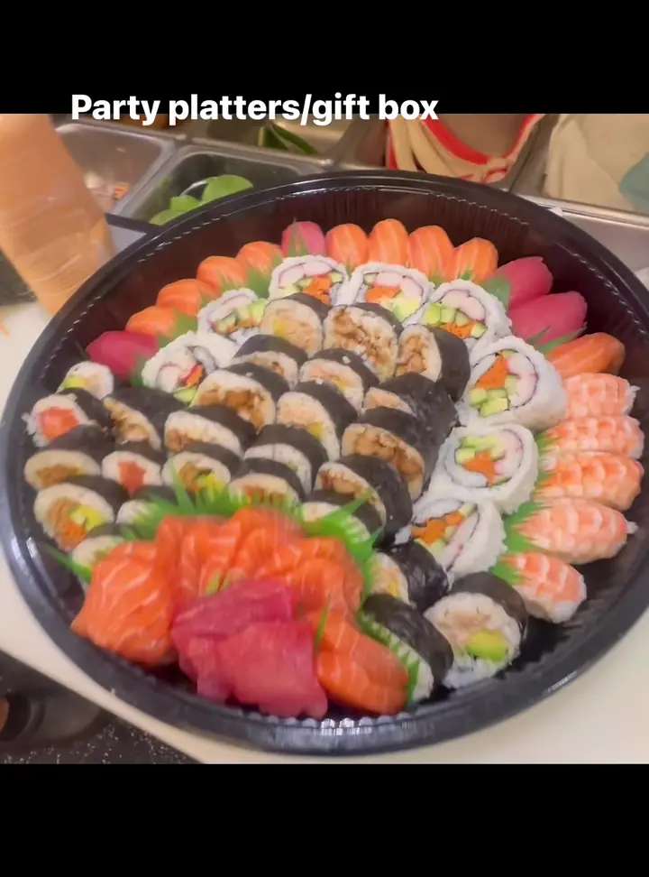 A Blessings party platter and gift box: rolls, fresh sushi and sashimi on a round black platter